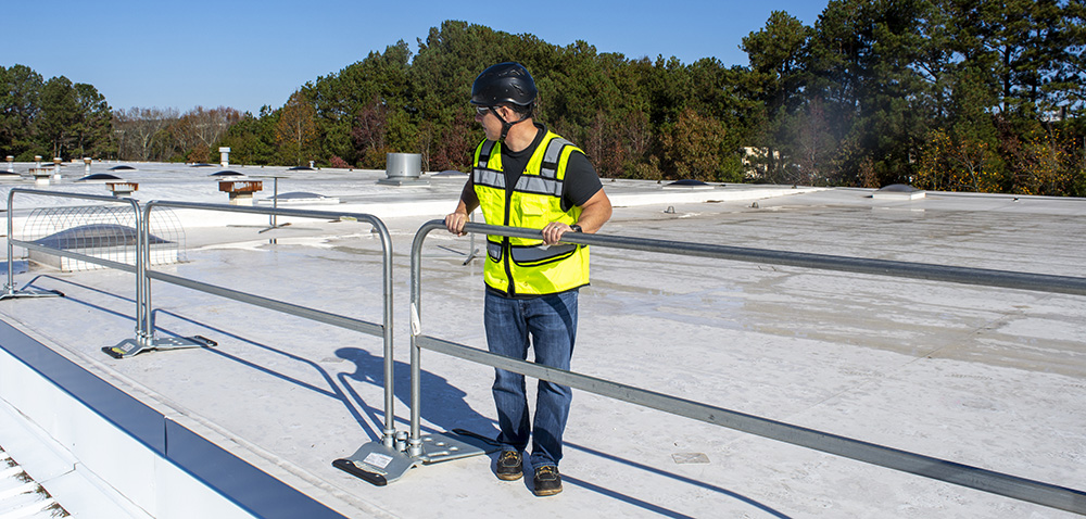 Image of a person on a rooftop with guardrails